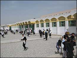 Children outside at recess at a newly built middle school, one of the 50 schools being built or repaired as part of Canada's education signature project.