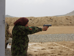 A member of Malalai Company, part of the Female Training Battalion at the Kabul Military Training Centre, shoots the final performance objective check on the 9-mm pistol.