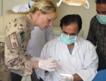 A soldier talks to dentists in Afghanistan.