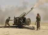 Soldiers fire an artillery gun at the Kabul Military Training Centre.