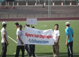 Children holding a sign for the Special Olympics in Afghanistan in the Ghazni Stadium in Kabul.