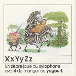 Page from book, L'ALPHABET, with an illustration of zebras playing the xylophone and text that includes X, Y and Z words