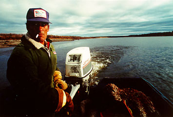 picture of Stephen Frost hunting caribou in a boat on the Porcupine River