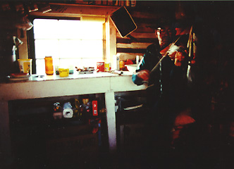 picture of Charlie Peter Charlie Senior playing a fiddle in a house