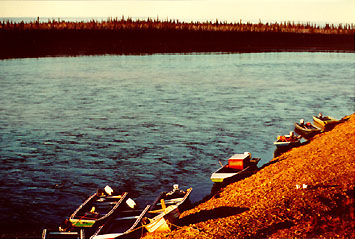 picture of boats tied up on Porcupine River in front of Old Crow