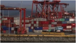 Still image of cranes and colourful cargo containers.