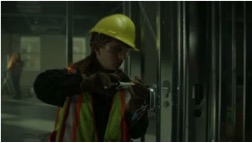 Still image, female electrician at work.