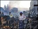 Image number 14: woman emerging from a fire or ruins in her town