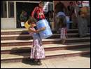 Image number 1: girl holding a water barrel