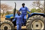 Image number 12: two adults on a tractor