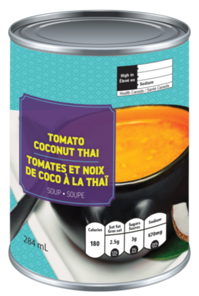There is an image of the front panel of a can of soup called Tomato Coconut Thai. In the top right corner is the black rectangle nutrition symbol with the Health Canada attribution indicating that the product is high in sodium. In the bottom right corner of the label is numeric nutrition information indicating that the product contains 180 calories, 2.5 g of saturated fat, 3 g of sugars and 670 mg of sodium.