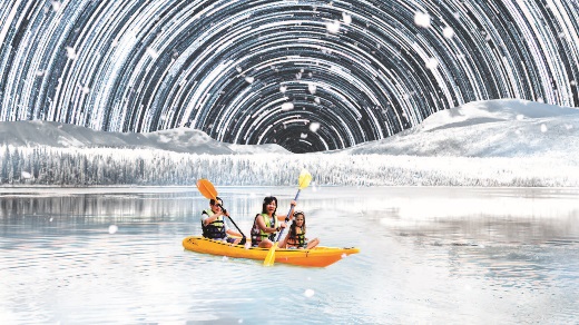 A family kayaks under stars