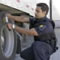 A CBSA officer verifies a truck tire using a densimeter that is used to determine the density of a surface or object. The meters can discover hidden walls and help detect contraband.