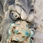 A poultice partially covers a gargoyle to draw out copper staining and salt