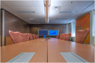 Large formal boardroom with videopresence equipment, modern design and art on display at pilot project in Ottawa, ON
