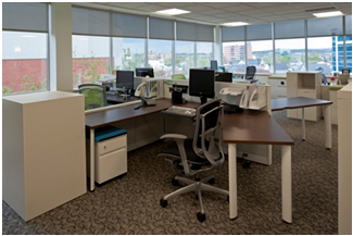 Open concept workstations with glass toppers and ergonomic furniture maximize airflow and natural light in Gatineau, QC