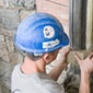 A construction worker rehabilitates a window arch, Southeast Tower, West Block