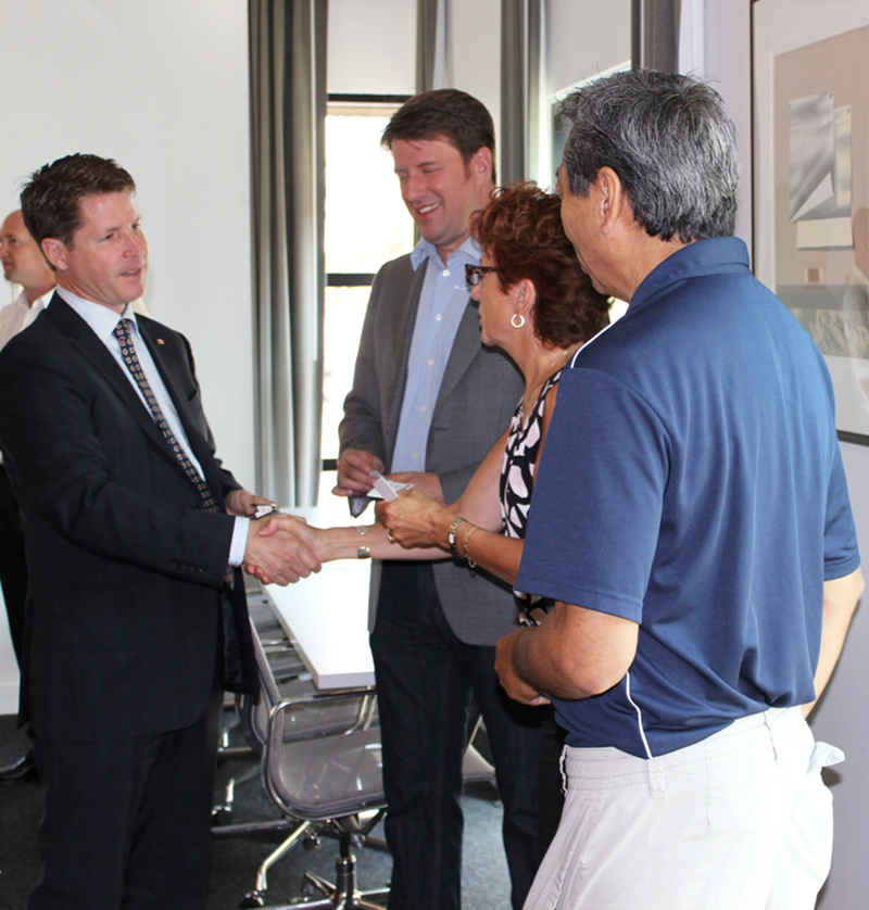 A man shaking people's hands.