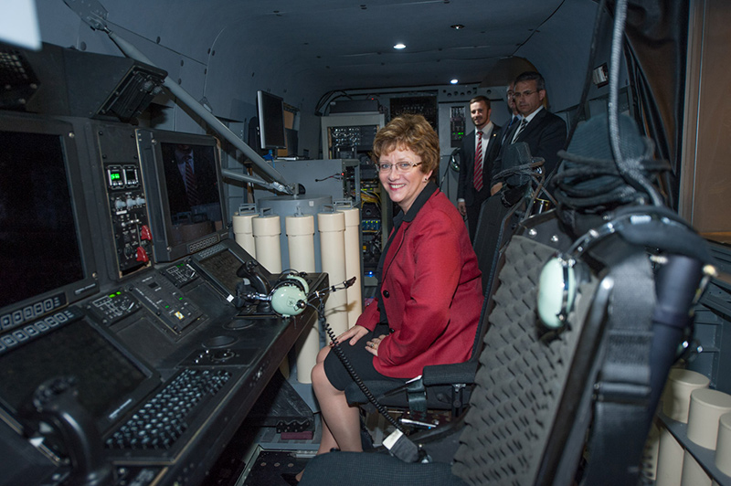 A woman sitting in a simulated helicopter.