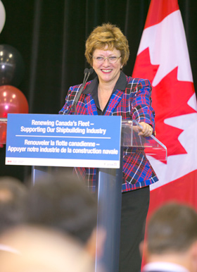 A woman standing behind a podium.