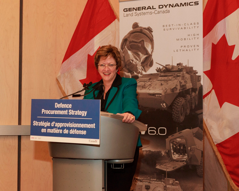 A woman standing behind a podium.