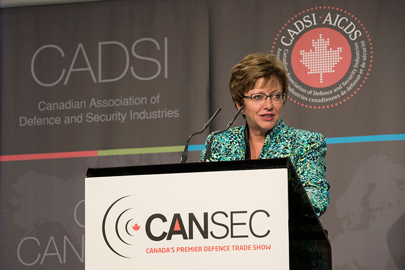 A woman standing behind a podium.