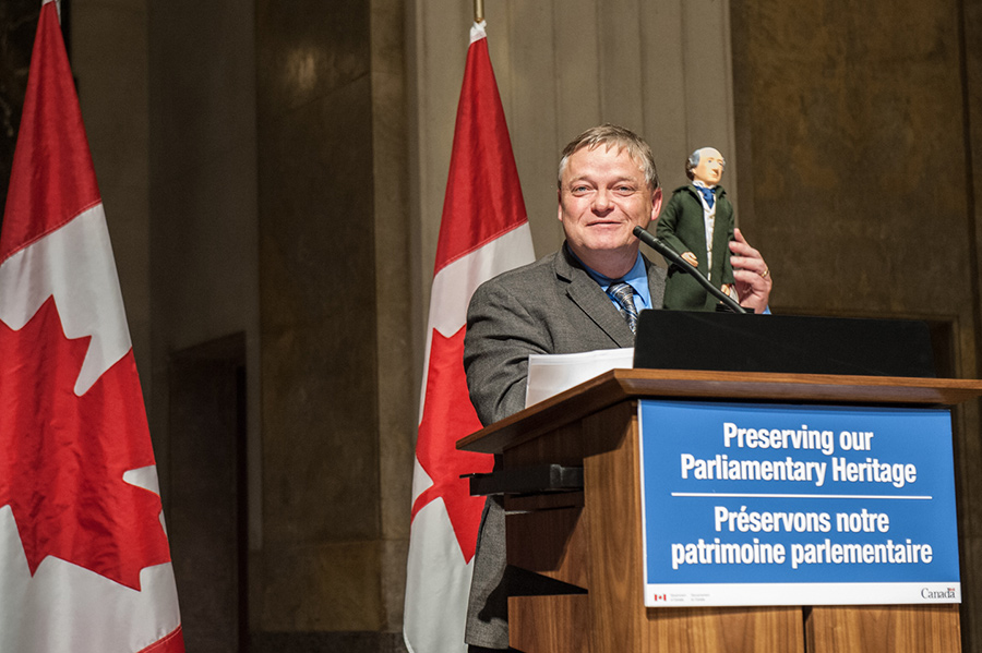 Man standing behind a podium.