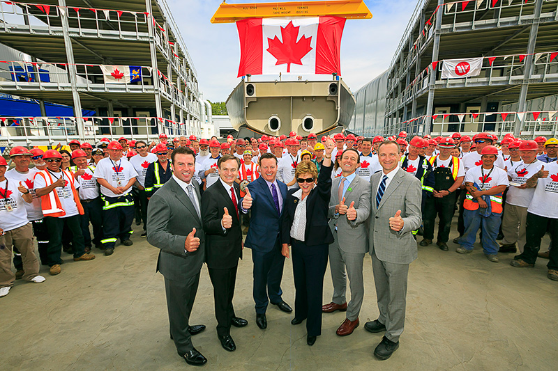 A group of men and a woman posing for a photo.