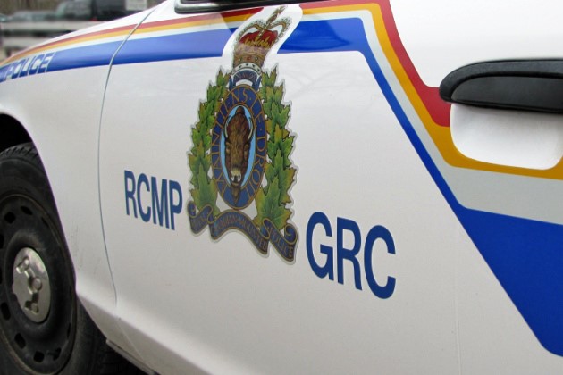 The driver side door of a Royal Canadian Mounted Police sedan.