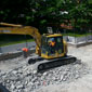 Construction vehicles demolishing and removing concrete.