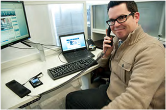 Employee making a phone call using a handset attachment for Smartphones, Ottawa, ON