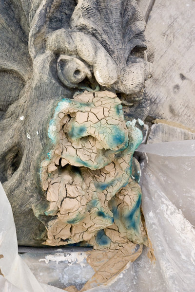 View enlarged image of a poultice partially covering one of the Peace Tower's gargoyles to draw out copper staining and salt