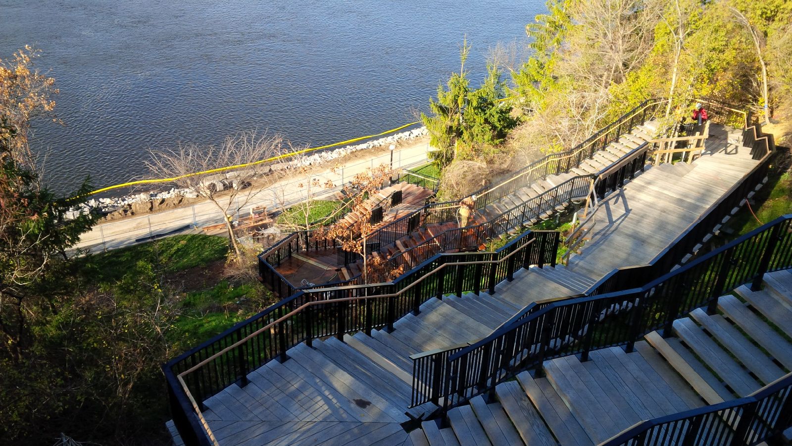 Overhead image of a worker staining the wooden staircase of Parliament Hill’s north-east escarpment