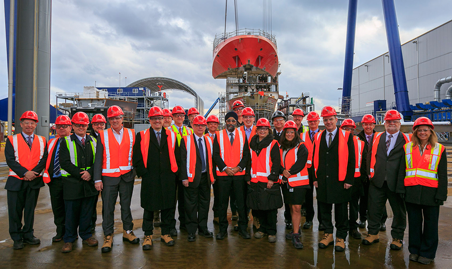 A group of people standing together and smiling.