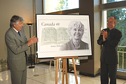 Roch Carrier (left) and Frédéric Brochu, Archivist at the Université de Sherbrooke, which houses the Centre Anne-Hébert, unveiling the stamp honouring Anne Hébert