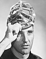 Photograph of Jacques Plante holding his face mask