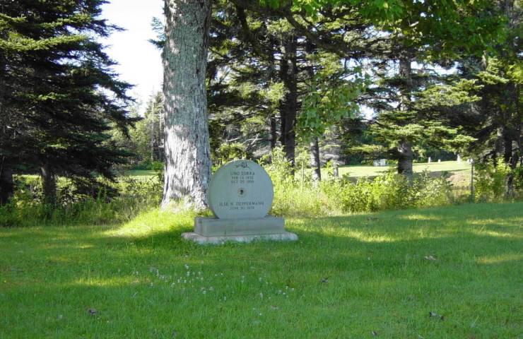 Grindstone tombstone at Minudie