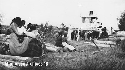 Natives with Steamer taking on wood