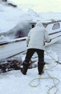 Man freeing boat from ice.