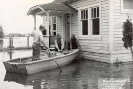 Row boat at the front door of Ronald W. and Dorothy Toop home during the Fraser River flood of 1948. P666