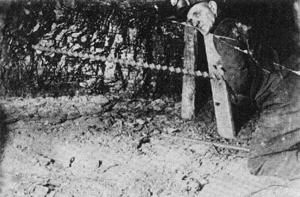 "Drilling by hand into longwall face of coal seam"