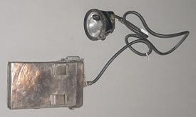 "Miner's lamp, cord, battery"