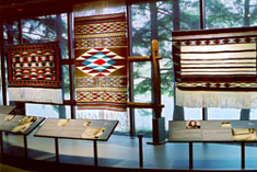 Musqueam Weavers module in 'Gathering Strength Exhibit' at MOA, photo 2002.  Courtesy UBC Museum of Anthropology, photo by Cliff Lauson