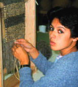 Krista Point weaving on a small table-top loom, photo 1996.  Photo Courtesy Krista Point