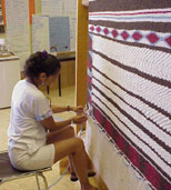 Lynn Dan at loom weaving a large-scale blanket, now in MOA collection, #Nbz856, photo 1999. Courtesy UBC Museum of Anthropology, photo by Jill Baird