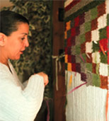 Debra Sparrow weaving a blanket now on permanent display at MOA. Photo by Jill Baird