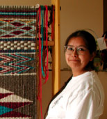 Vivian Campbell beside her nearly completed weaving now in MOA collection, #Nbz854, photo 2001. Courtesy UBC Museum of Anthropology, photo by Jill Baird