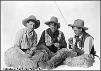 three seated cowboys in full gear