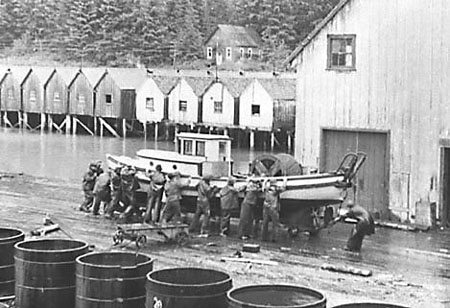 Boat repair at North Pacific Cannery, housing in the background
