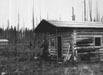 Man in front of cabin
